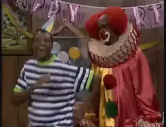 Clown dances with man at party