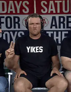 Man in Yikes shirt reacting