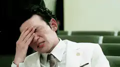 Man in white suit facepalm crying