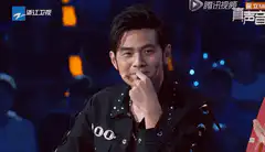 Jay Chou smiling and touching his chin