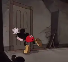 Mickey Mouse tries to open a door