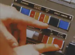 Hand pressing buttons on control panel