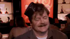 Ron Swanson wearing a party hat