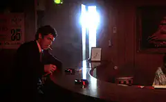 man at bar with bright light