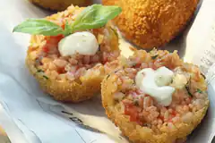 Fried rice balls with mozzarella and basil