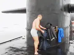 Man slips off submarine ladder into icy water