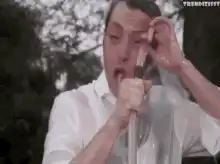 Man holding a hose with water spraying