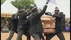 Ghanaian pallbearers dancing with coffin
