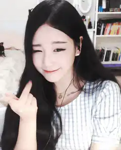 Girl winking and making finger heart
