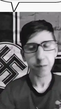 Nostr build guy talking in front of flag