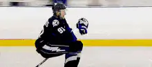 Hockey player skating past camera