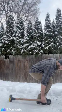 Man swinging sledgehammer in snow