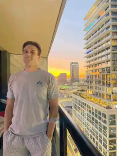 Man on balcony with rainbow lens flare