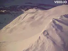 Skier falls after skiing down a mountain