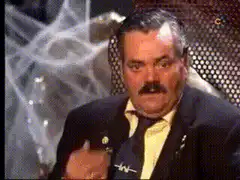 Man with mustache laughing and giving thumbs up