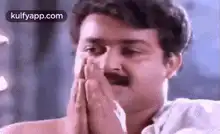Man praying with hands together