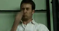 man rubbing nose
