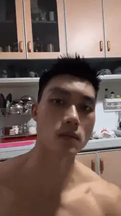 shirtless man eating cotton candy