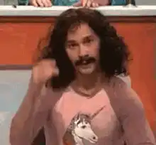 Man doing magic trick with unicorn shirt