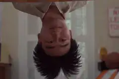 man upside down looking confused