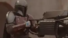 The Mandalorian fires his blaster