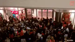 Crowd rushing into a store