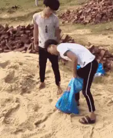 Girl falls backward into sand
