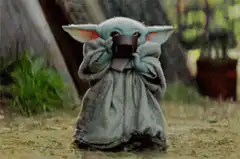 Baby Yoda drinking from a cup