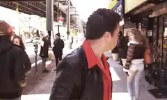 Jimmy Fallon eating a hot dog on the street
