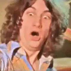 Man with curly hair making shocked face