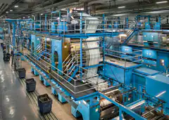 Large industrial printing press in factory