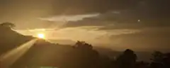 Sunset over mountains with lens flare