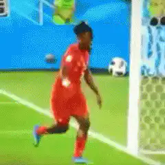 Soccer player kicks ball into net