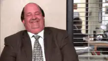 Man in suit smiling and nodding