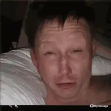 Man lying in bed looking tired