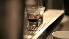 Espresso pouring into shot glasses