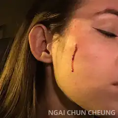 Woman with bloody cheek and mirror