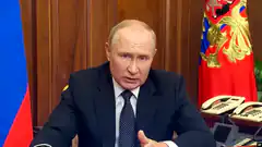 Vladimir Putin speaking at desk