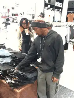 Man in beanie grabs jeans and runs