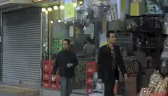 Man kicks flower wreath while walking