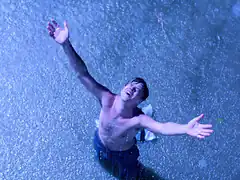 Man reaching up in rain