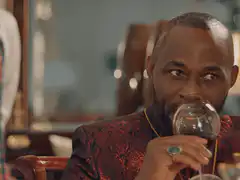 Man drinking wine plots silently