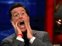 Stephen Colbert screaming with hands on face