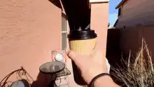 Hand passing coffee cup through window