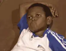 Boy on couch looking bored