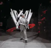 John Cena walking with WWE logo