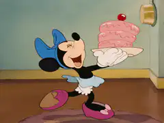 Minnie Mouse presenting a pink cake