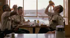 Three cops drinking beer in a diner