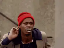 Dave Chappelle smoking and looking around