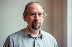 Man with glasses and goatee smiling